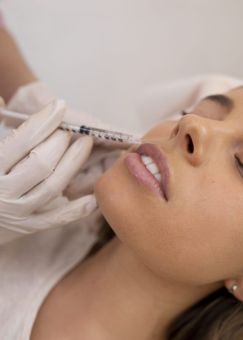 close-up-woman-getting-lip-filler-with-injection